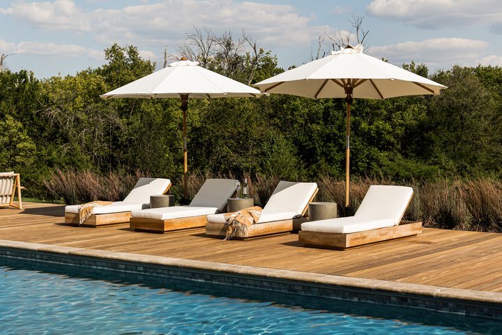 Outdoor seating by the pool in Flint Hills by Pure Salt