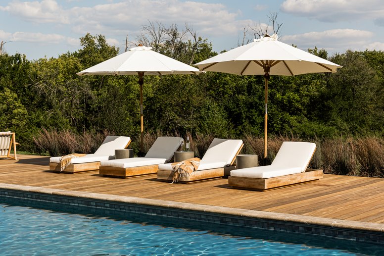 Outdoor seating by the pool in Flint Hills by Pure Salt